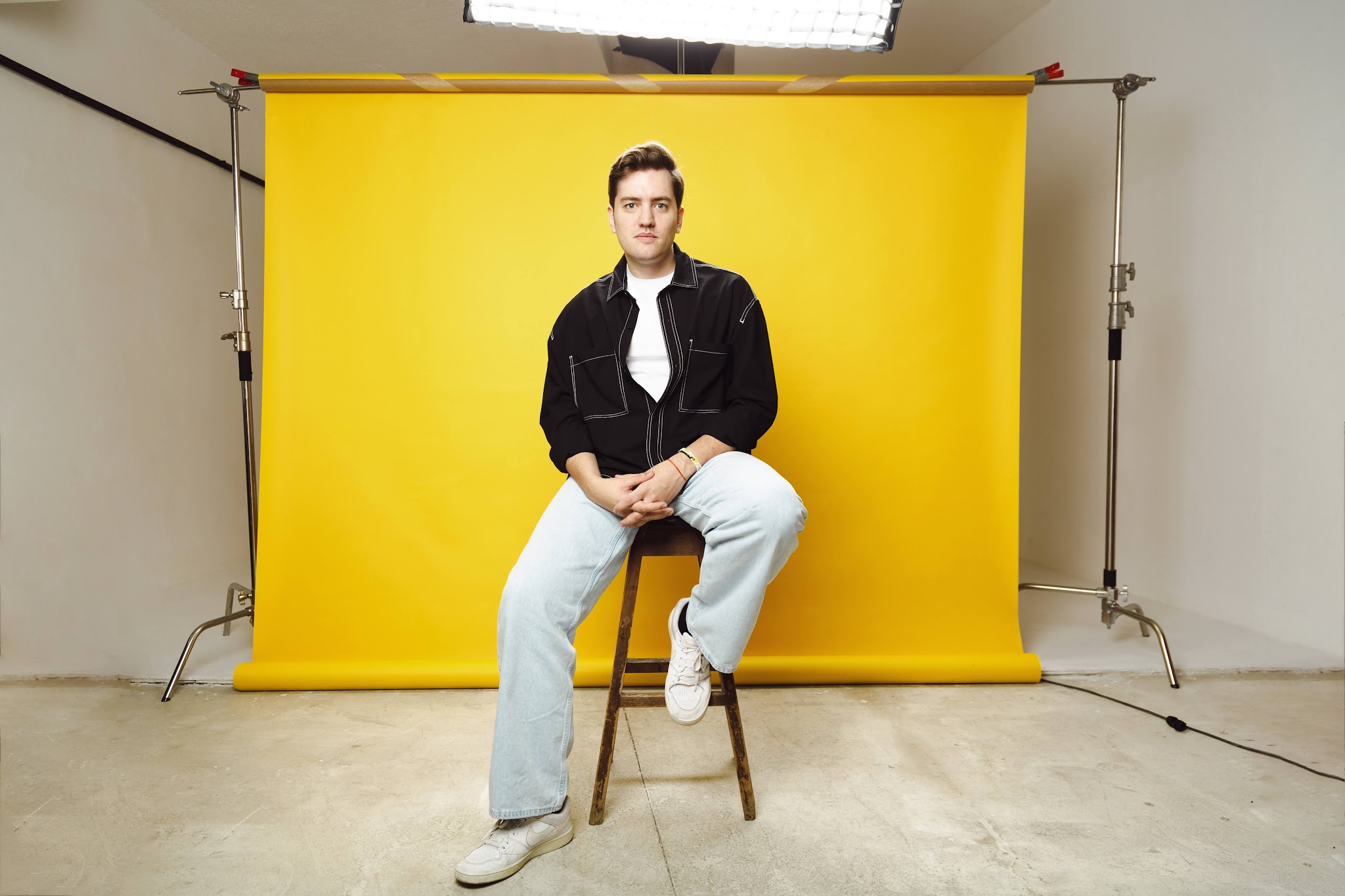 Studio portrait of Jorge Ferreiro on a yellow set